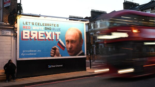 A Brexit-themed billboard depicting Russian President Vladimir Putin that reads Lets celebrate a red, white and blue Brexit is seen in north London on November 8, 2018 - Sputnik International
