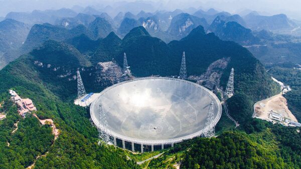 In this Saturday, Sept. 24, 2016 photo released by Xinhua News Agency, an aerial view shows the Five-hundred-meter Aperture Spherical Telescope (FAST) in the remote Pingtang county in southwest China's Guizhou province. China has begun operating the world's largest radio telescope to help search for extraterrestrial life - Sputnik International