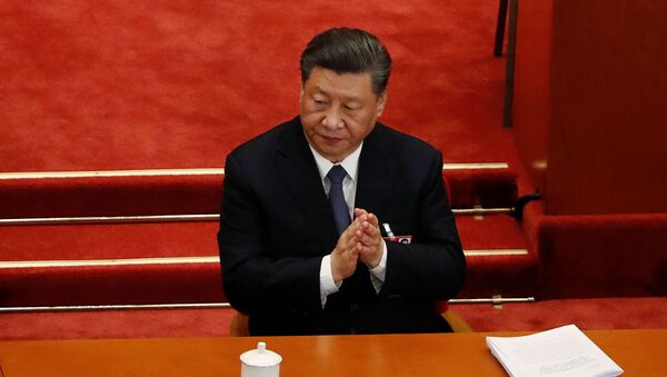 Chinese President Xi Jinping claps his hands at the opening session of the National People's Congress (NPC) at the Great Hall of the People in Beijing, China May 22, 2020. - Sputnik International
