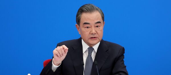 Chinese State Councillor and Foreign Minister Wang Yi speaks to reporters via video link at a news conference held on the sidelines of the National People's Congress (NPC), from the Great Hall of the People in Beijing, China May 24, 2020. - Sputnik International