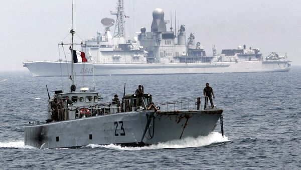 Backdropped by French Navy ship Jean Bart, a French landing vessel carrying a bulldozer and military jeeps approaches the port of the southern border town of Naqoura, Lebanon, next to the headquarters of United Nations Interim Force In Lebanon, or UNIFIL, Saturday Aug. 19, 2006 - Sputnik International