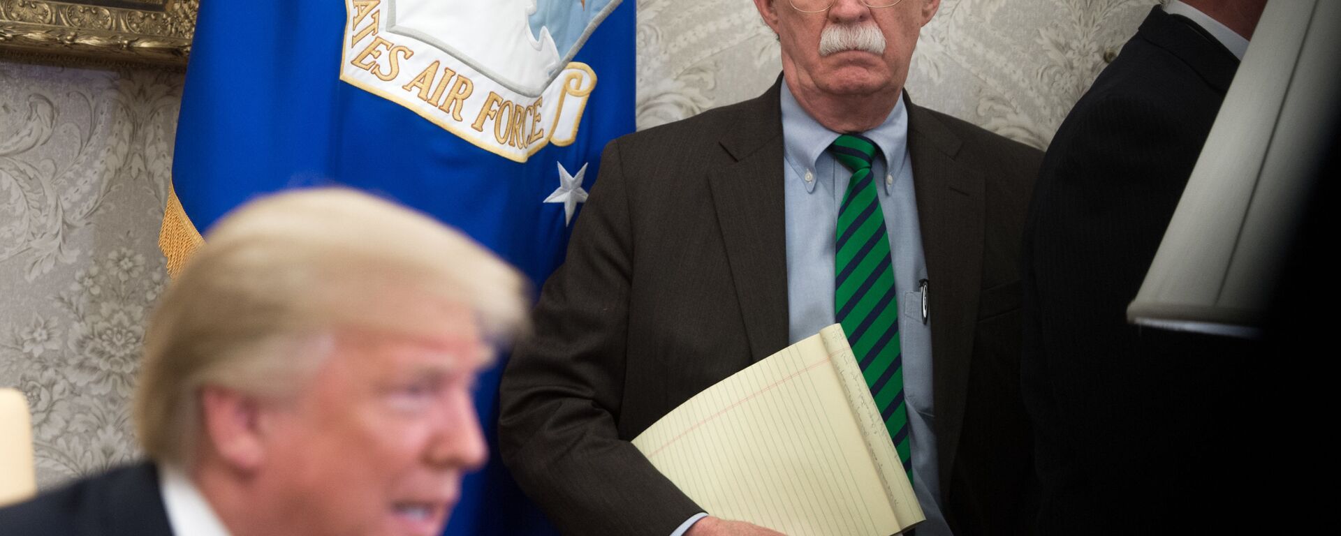  In this file photo National Security Adviser John Bolton stands alongside US President Donald Trump as he speaks during a meeting with NATO Secretary General Jens Stoltenberg in the Oval Office of the White House in Washington, DC, May 17, 2018. - The US Justice Department filed an emergency order Wednesday seeking to halt release of ex-national security advisor John Bolton's book, the second time in two days that President Donald Trump tried to block the tell-all memoir.  - Sputnik International, 1920, 22.06.2020