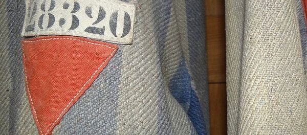 Prisoners' Uniforms with Red Triangles of Political Prisoners. Museum Exhibit, Dachau Concentration Camp Site Prisoners' Uniforms with Red Triangles of Political Prisoners. Museum Exhibit, Dachau Concentration Camp Site - Sputnik International