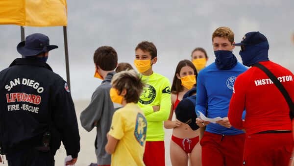 Instructors gather participants on the beach as San Diego's Junior Lifeguard Program officially reopens with new protocols in place to comply with county health guidelines for novel coronavirus safety during the outbreak of COVID-19 in San Diego, California, U.S., June 15, 2020 - Sputnik International