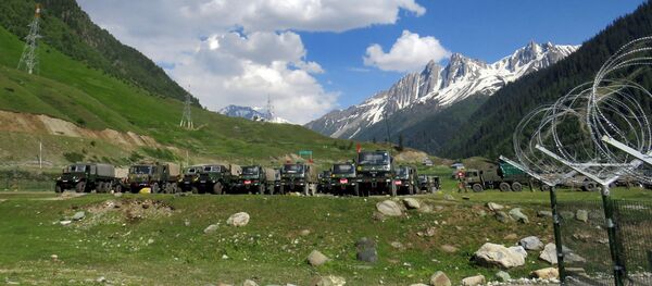 Indian army soldiers walk past their parked trucks at a makeshift transit camp before heading to Ladakh, near Baltal, southeast of Srinagar, June 16, 2020. Indian army soldiers walk past their parked trucks at a makeshift transit camp before heading to Ladakh, near Baltal, southeast of Srinagar, June 16, 2020. - Sputnik International