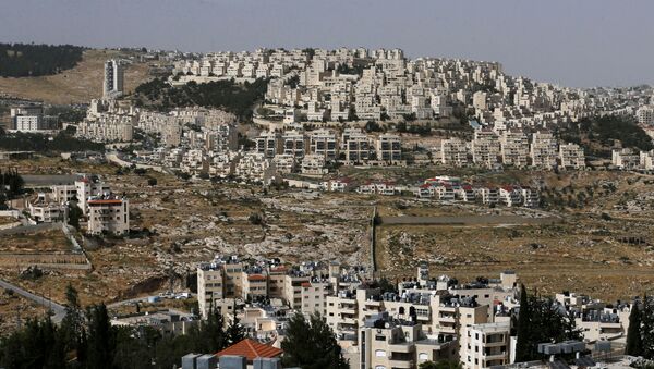 A view shows the Israeli settlement of Har Homa in the background as Palestinian houses are seen in the foreground, in the Israeli-occupied West Bank, May 19, 2020. Picture taken May 19, 2020.  - Sputnik International