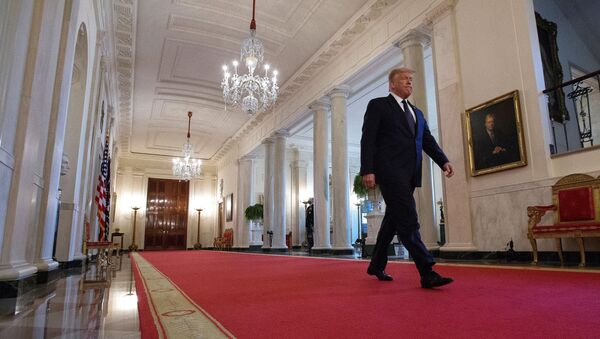 U.S. President Donald Trump walks down Cross Hall ahead of an event held to discuss an administration plan aimed at helping to prevent suicides by U.S. veterans and other Americans, at the White House in Washington, U.S., June 17, 2020.  - Sputnik International