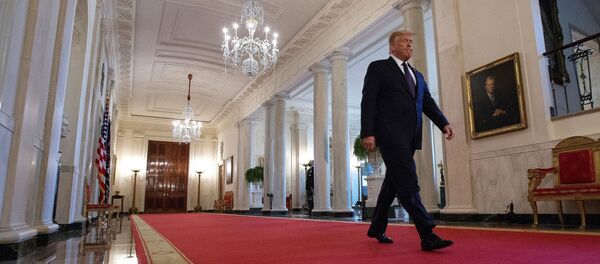 U.S. President Donald Trump walks down Cross Hall ahead of an event held to discuss an administration plan aimed at helping to prevent suicides by U.S. veterans and other Americans, at the White House in Washington, U.S., June 17, 2020.  - Sputnik International