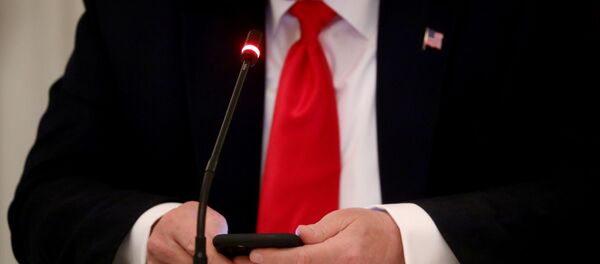 U.S. President Donald Trump is seen tapping the screen on a mobile phone during a roundtable discussion on the reopening of small businesses in the State Dining Room at the White House in Washington, U.S., June 18, 2020 U.S. President Donald Trump is seen tapping the screen on a mobile phone during a roundtable discussion on the reopening of small businesses in the State Dining Room at the White House in Washington, U.S., June 18, 2020 - Sputnik International