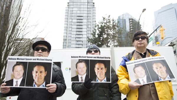 Protesters hold photos of Canadians Michael Spavor and Michael Kovrig, who are being detained by China, outside British Columbia Supreme Court, in Vancouver, on March 6, 2019, as Huawei Chief Financial Officer Meng Wanzhou appears in court. - Meng Wanzhou, the Chinese telecom executive at the center of an escalating row between Ottawa and Beijing, was due in court in Canada to get a date for a hearing into a US extradition request. Meng's arrest in Vancouver in December on a US warrant infuriated China, which arrested several Canadians days later in what was widely seen as retaliation. A Canadian judge on Wednesday who set May 8 for the start of a hearing into a US extradition request. - Sputnik International