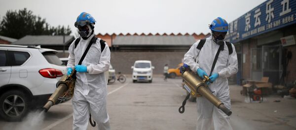 Volunteers from the Blue Sky Rescue team, in protective suits, disinfect the Nangong comprehensive market following a new outbreak of the coronavirus disease (COVID-19) in Beijing, China, June 18, 2020. Picture taken June 18, 2020. REUTERS/Carlos Garica Rawlins - Sputnik International
