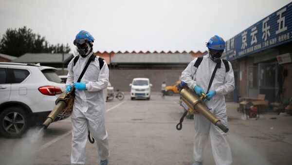Volunteers from the Blue Sky Rescue team, in protective suits, disinfect the Nangong comprehensive market following a new outbreak of the coronavirus disease (COVID-19) in Beijing, China, June 18, 2020. Picture taken June 18, 2020. REUTERS/Carlos Garica Rawlins - Sputnik International