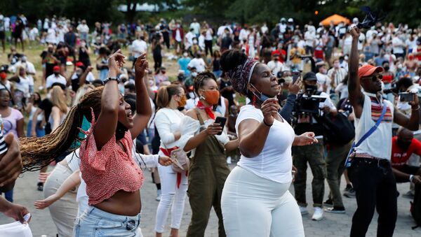 People take part in events to mark Juneteenth, which commemorates the end of slavery in Texas, two years after the 1863 Emancipation Proclamation freed slaves elsewhere in the United States, amid nationwide protests against racial inequality, in the Harlem neighbourhood of Manhattan, in New York City, New York, U.S., June 19, 2020. - Sputnik International