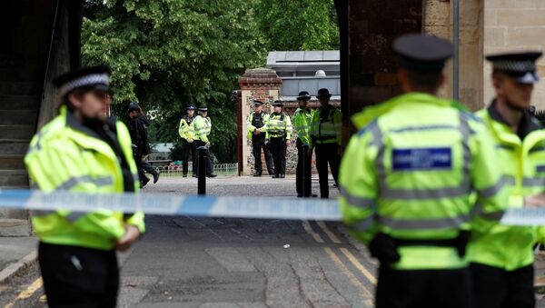 Police officers stand behind the cordon at the scene of multiple stabbings in Reading, Britain, June 21, 2020. - Sputnik International