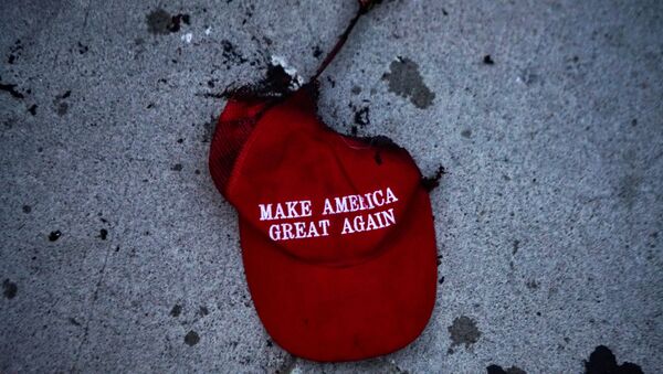 A burnt Make America Great Again (MAGA) hat lies on the ground during a protest against racial injustice near the site of a rally by U.S. President Donald Trump in Tulsa, Oklahoma, U.S., June 20, 2020. - Sputnik International