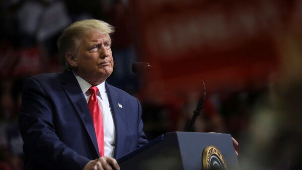 U.S. President Donald Trump stands at the podium listening to his supporters cheer as he addresses his first re-election campaign rally in several months in the midst of the coronavirus disease (COVID-19) outbreak, at the BOK Center in Tulsa, Oklahoma, U.S., June 20, 2020 - Sputnik International