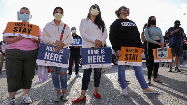 People hold signs as they take part in a rally for Justice Everywhere to celebrate the U.S. Supreme Court's ruling to disallow the rescinding of the Deferred Action for Childhood Arrivals (DACA) program, in San Diego, California, U.S., June 18, 2020. - Sputnik International