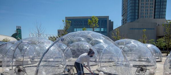 An employee cleans the dome before an outdoor yoga class by LMNTS Outdoor Studio, in a dome to facilitate social distancing and proper protocols to prevent the spread of coronavirus disease (COVID-19), in Toronto, Ontario, Canada June 21, 2020. - Sputnik International