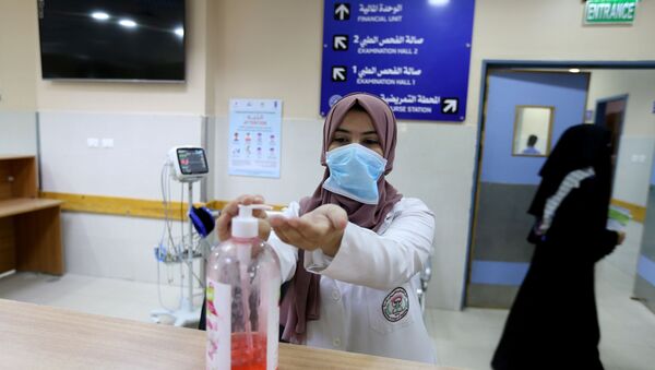 A Palestinian nurse sanitizes her hands in a hospital amid the coronavirus disease (COVID-19) crisis, in the southern Gaza Strip June 9, 2020. - Sputnik International