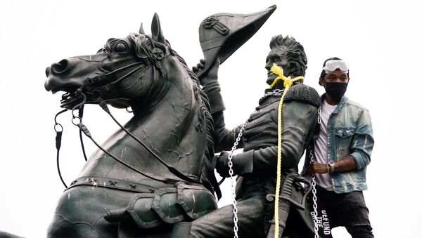 A protestors wraps chains and ropes around the statue of U.S. President Andrew Jackson during an attempt by protestors to pull the statue down in the middle of Lafayette Park in front of the White House during racial inequality protests in Washington, D.C., U.S., June 22, 2020 - Sputnik International