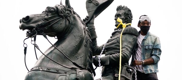 A protestors wraps chains and ropes around the statue of U.S. President Andrew Jackson during an attempt by protestors to pull the statue down in the middle of Lafayette Park in front of the White House during racial inequality protests in Washington, D.C., U.S., June 22, 2020 - Sputnik International