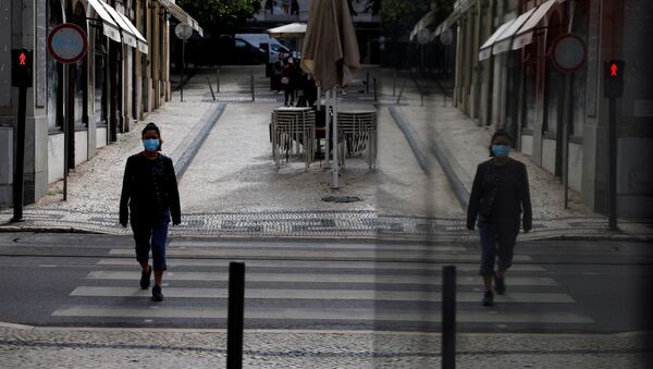 A woman wearing a protective mask walks, amid the coronavirus disease (COVID-19) outbreak, in downtown Lisbon, Portugal, May 14, 2020 - Sputnik International