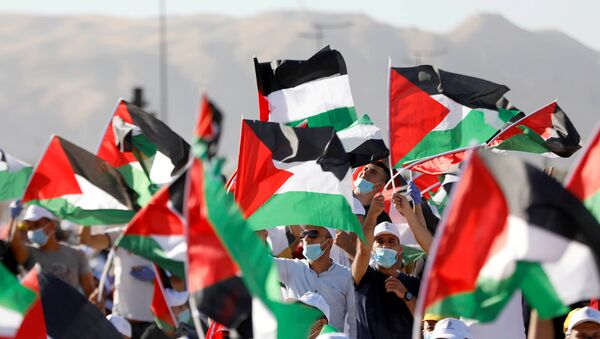 Demonstrators take part in a rally, organised by the Palestinian Liberation Organization (PLO), to protest against Israel's plan to annex parts of the occupied West Bank, in Jericho June 22, 2020 - Sputnik International