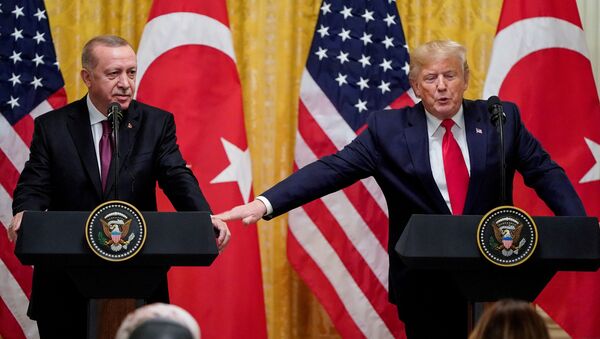 U.S. President Donald Trump reaches to Turkey's President Tayyip Erdogan during a joint news conference at the White House in Washington, U.S., November 13, 2019 - Sputnik International