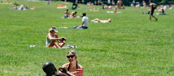 People enjoy the weather in Central Park, the day before the city starts phase two of reopening after the lockdown due to the coronavirus disease (COVID-19), in the Manhattan borough of New York City, U.S., June 21, 2020 - Sputnik International