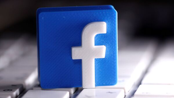 A 3D-printed Facebook logo is seen placed on a keyboard in this illustration taken March 25, 2020. - Sputnik International
