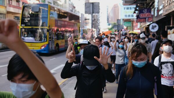 Pro-democracy protesters raise their hands up as a symbol of the Five demands, not one less during a march against the looming national security legislation in Hong Kong, China 28 June 2020. - Sputnik International