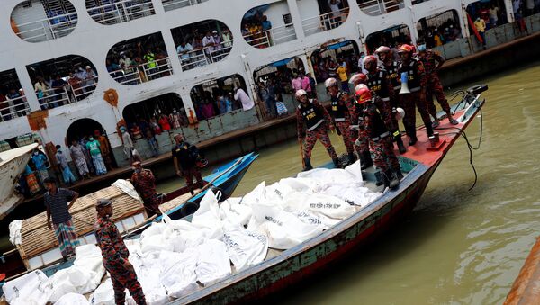 Rescue members stand near the bodies on a boat after a passenger ferry capsized in the river Buriganga in Dhaka, Bangladesh, June 29, 2020 - Sputnik International