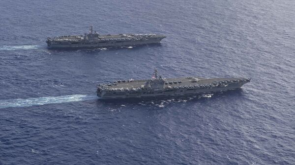 The Theodore Roosevelt Carrier Strike Group transits in formation with the Nimitz Carrier Strike Group while conducting dual carrier and airwing operations in the Philippine Sea June 23, 2020. - Sputnik International