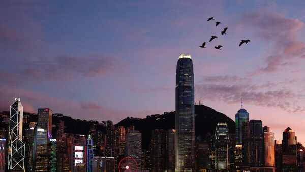 Birds fly above a sunset view and a skyline of buildings during a meeting on national security legislation, in Hong Kong, China June 29, 2020 - Sputnik International