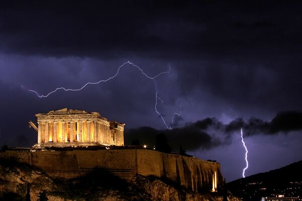 The ancient Greek Parthenon, a temple atop Acropolis hill overlooking Athens, is framed by lightning bolts during a thunderstorm that broke out in the Greek capital in October 2006 - Sputnik International