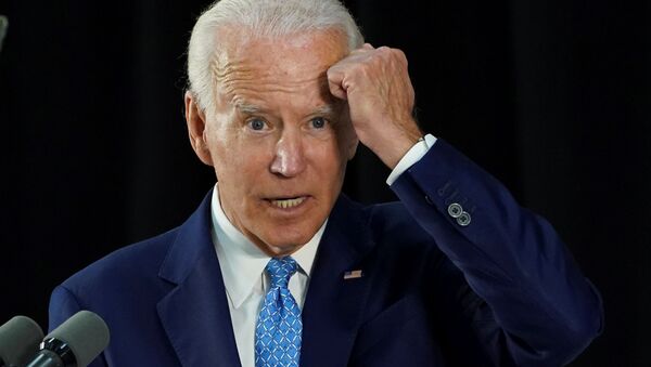 Democratic U.S. presidential candidate and former Vice President Joe Biden gestures with his fist towards his head as he says he has not been tested for coronavirus because he has had no symptoms as my mother would say, knock on wood while answering questions from reporters during a campaign event in Wilmington, Delaware, U.S., June 30, 2020. - Sputnik International