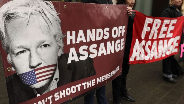 Demonstrators hold banners outside Westminster Magistrates Court in London, Wednesday, Feb. 19, 2020. A case-management hearing regarding Julian Assange will be heard at the court Wednesday - Sputnik International