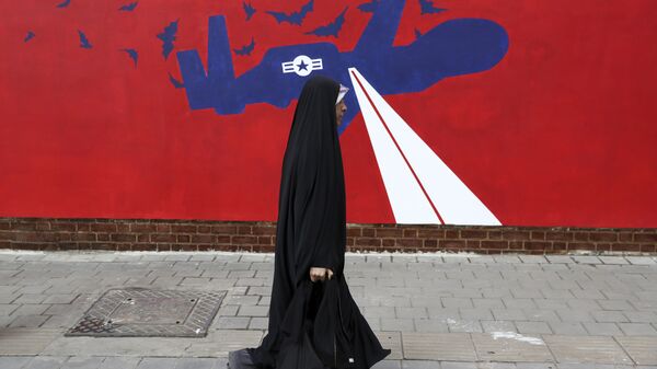 A woman walks past a new anti-U.S. mural on the wall of former U.S. embassy portraying the interception of Global Hawk US drone by Iran in Persian Gulf, after an unveiling ceremony in Tehran, Iran, Saturday, Nov. 2, 2019. - Sputnik International