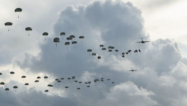 Paratroopers assigned to the 4th Infantry Brigade Combat Team (Airborne), 25th Infantry Division, U.S. Army Alaska, conduct a Joint Forcible Entry Operation (JFEO) jump into Andersen Air Force Base, Guam, June 30. - Sputnik International