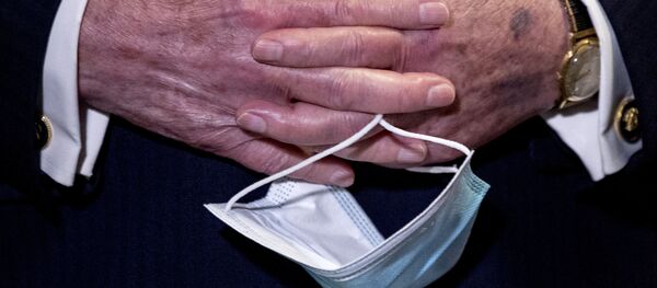 In this June 16, 2020, file photo Senate Majority Leader Mitch McConnell, R-Ky., holds a face mask in his hands during a news conference following a Senate policy luncheon on Capitol Hill in Washington. In this June 16, 2020, file photo Senate Majority Leader Mitch McConnell, R-Ky., holds a face mask in his hands during a news conference following a Senate policy luncheon on Capitol Hill in Washington. - Sputnik International