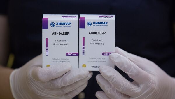 An employee demonstrates packages with new antiviral drug Avifavir, produced by manufacturer ChemRar and approved by Russian authorities to treat patients suffering from the coronavirus disease (COVID-19), at a storage in Moscow, Russia, in this handout photo released June 10, 2020 - Sputnik International
