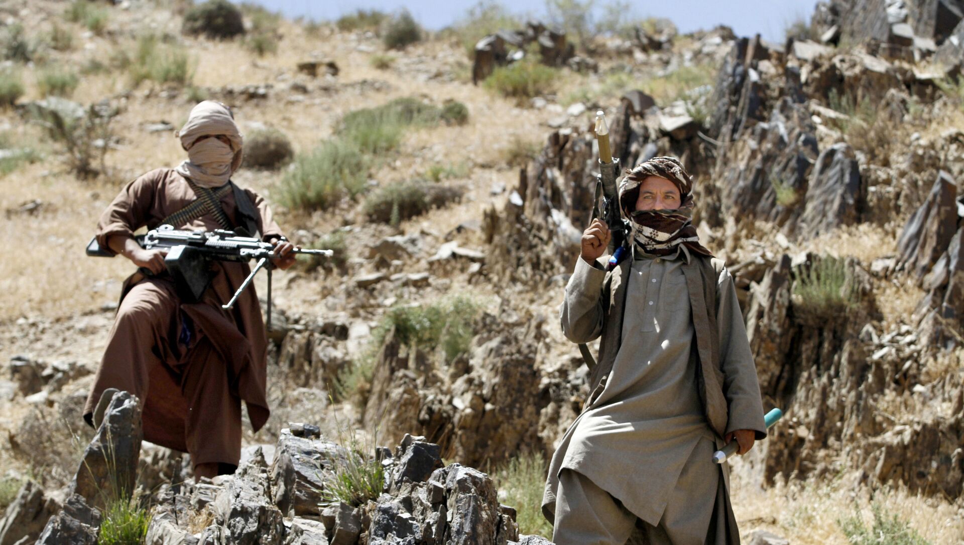 In this Friday, May 27, 2016 photo, Taliban fighters stand guard as senior leader of a breakaway faction of the Taliban Mullah Abdul Manan Niazi, not pictured, delivers a speech to his fighters, in Shindand district of Herat province, Afghanistan - Sputnik International, 1920, 23.07.2021