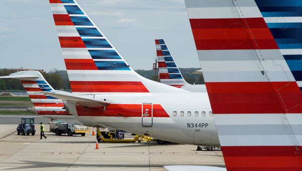  A member of a ground crew walks past American Airlines planes parked at the gate during the coronavirus disease (COVID-19) outbreak at Ronald Reagan National Airport in Washington, U.S., April 5, 2020. - Sputnik International