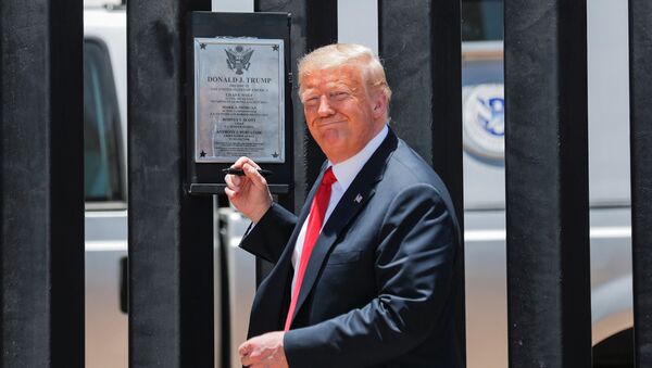 U.S. President Donald Trump smiles as he prepares to autograph a plaque commemorating the construction of the 200th mile of border wall while visiting the wall on the U.S.-Mexico border in San Luis, Arizona, U.S., June 23, 2020.  - Sputnik International