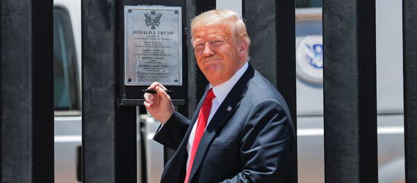 U.S. President Donald Trump smiles as he prepares to autograph a plaque commemorating the construction of the 200th mile of border wall while visiting the wall on the U.S.-Mexico border in San Luis, Arizona, U.S., June 23, 2020.  - Sputnik International