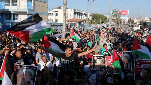 Palestinians take part in a protest against Israel's plan to annex parts of the Israeli-occupied West Bank, in Khan Younis in the southern Gaza Strip July 2, 2020.  - Sputnik International