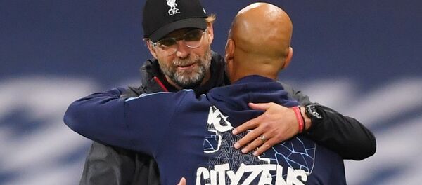 Liverpool manager Juergen Klopp with Manchester City manager Pep Guardiola after the match, as play resumes behind closed doors following the outbreak of the coronavirus disease (COVID-19). Liverpool manager Juergen Klopp with Manchester City manager Pep Guardiola after the match, as play resumes behind closed doors following the outbreak of the coronavirus disease (COVID-19). - Sputnik International