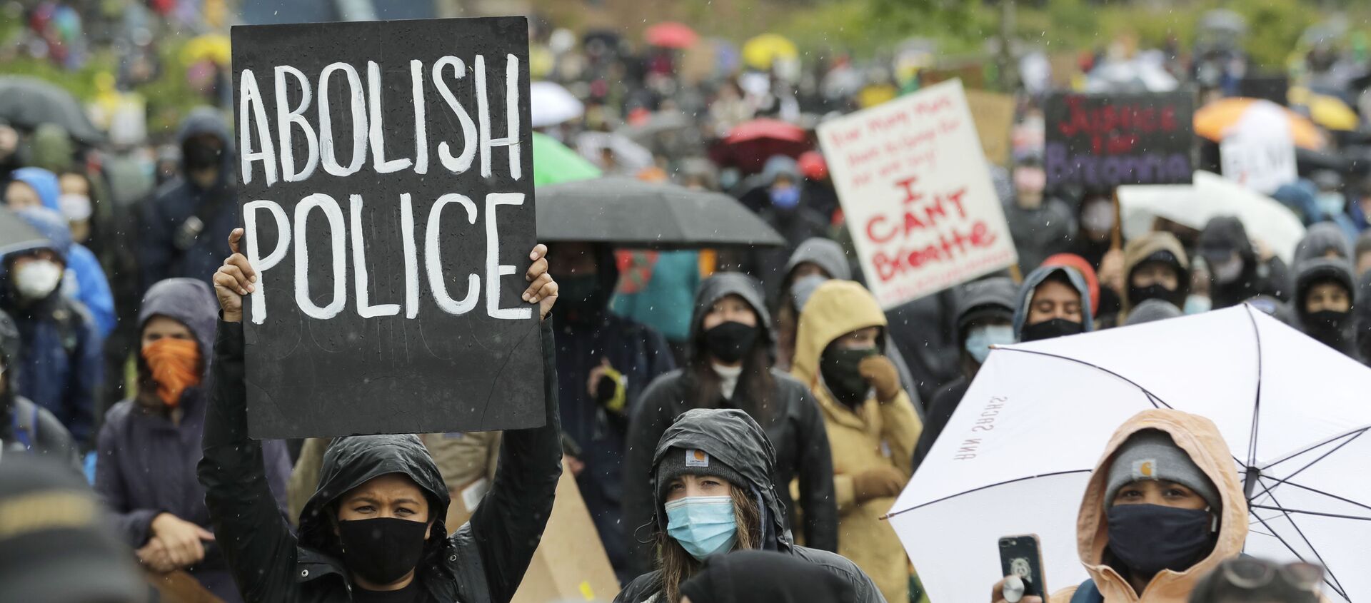 A protester holds a sign that reads Abolish Police during a Silent March against racial inequality and police brutality that was organized by Black Lives Matter Seattle-King County, Friday, 12 June 2020, in Seattle - Sputnik International, 1920, 27.07.2021