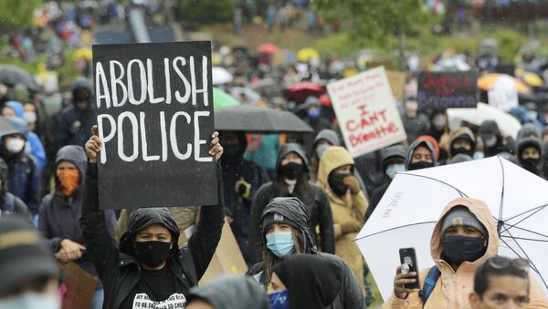 A protester holds a sign that reads Abolish Police during a Silent March against racial inequality and police brutality that was organized by Black Lives Matter Seattle-King County, Friday, June 12, 2020, in Seattle - Sputnik International