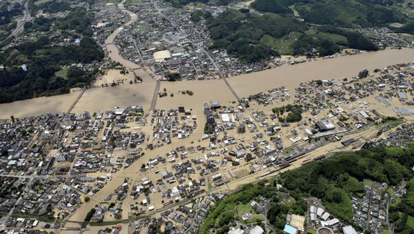 An aerial view shows flooded Kuma River caused by heavy rain at a residential area in Hitoyoshi, Kumamoto prefecture, southern Japan, in this photo taken by Kyodo 4 July  2020.  - Sputnik International